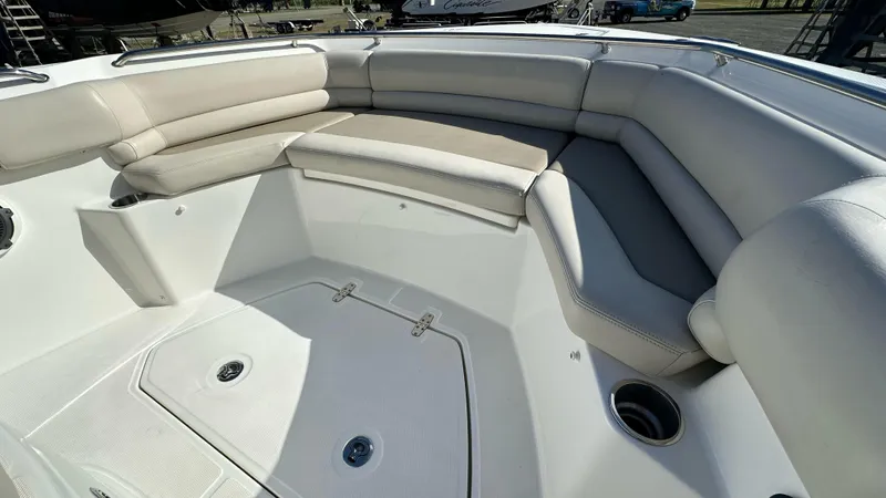  Yacht Photos Pics 2022 Boston Whaler 330 Outrage boat interior with cushioned seating and storage compartments.