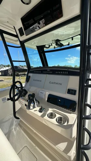  Yacht Photos Pics 2022 Boston Whaler 330 Outrage helm with Garmin navigation systems and steering wheel.