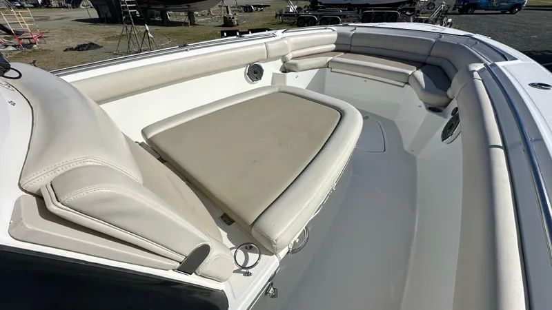  Yacht Photos Pics 2022 Boston Whaler 330 Outrage boat interior with cushioned seating and spacious layout.