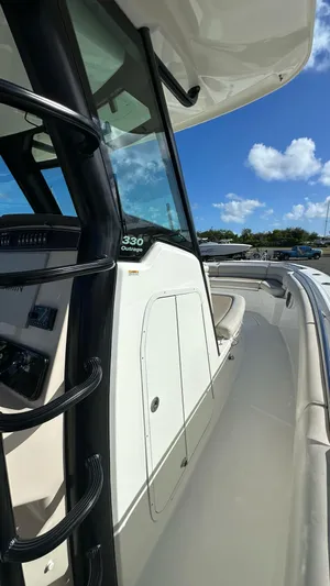  Yacht Photos Pics 2022 Boston Whaler 330 Outrage boat, sleek design, sunny day, blue sky, luxury features.