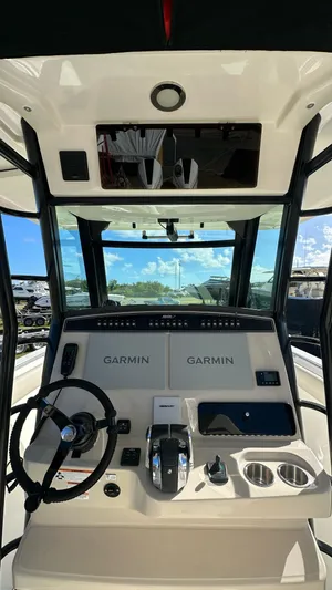  Yacht Photos Pics 2022 Boston Whaler 330 Outrage helm with Garmin navigation system and steering wheel.