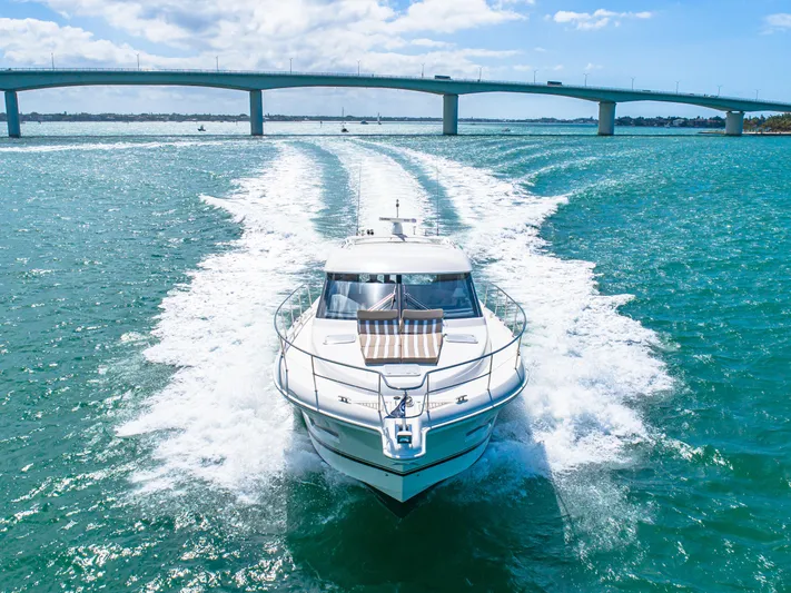 Belle-rosa Yacht Photos Pics 2016 Riviera 5000 Sport Yacht cruising under a bridge.