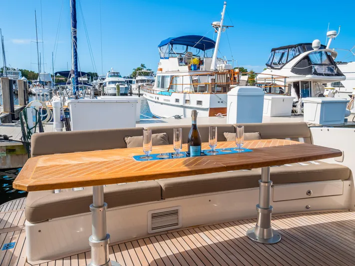 Belle-rosa Yacht Photos Pics Riviera 5000 Sport Yacht 2016 with set table in marina.