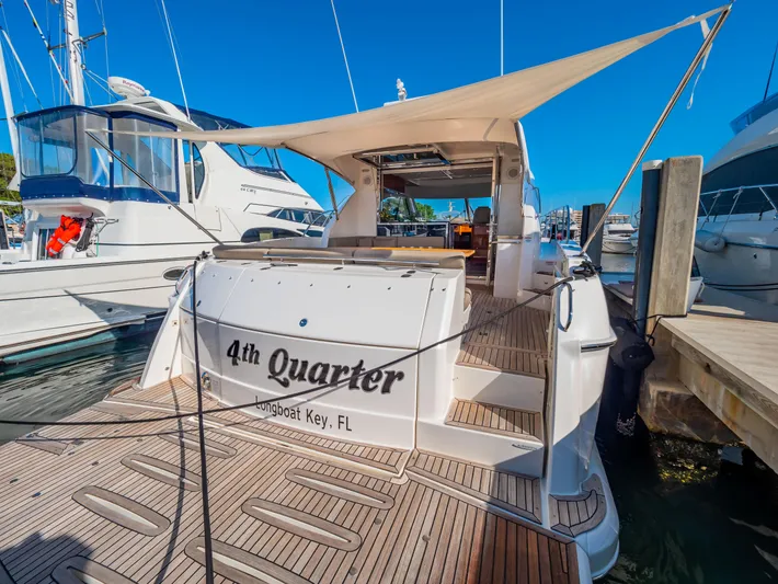 Belle-rosa Yacht Photos Pics 2016 Riviera 5000 Sport Yacht docked with sunshade and wooden deck.