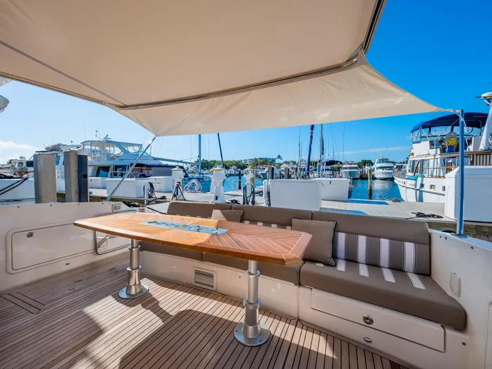 Belle-rosa Yacht Photos Pics 2016 Riviera 5000 Sport Yacht with elegant outdoor seating at marina.