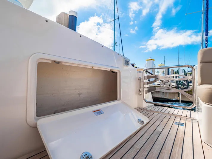 Belle-rosa Yacht Photos Pics 2016 Riviera 5000 Sport Yacht with open deck storage compartment.