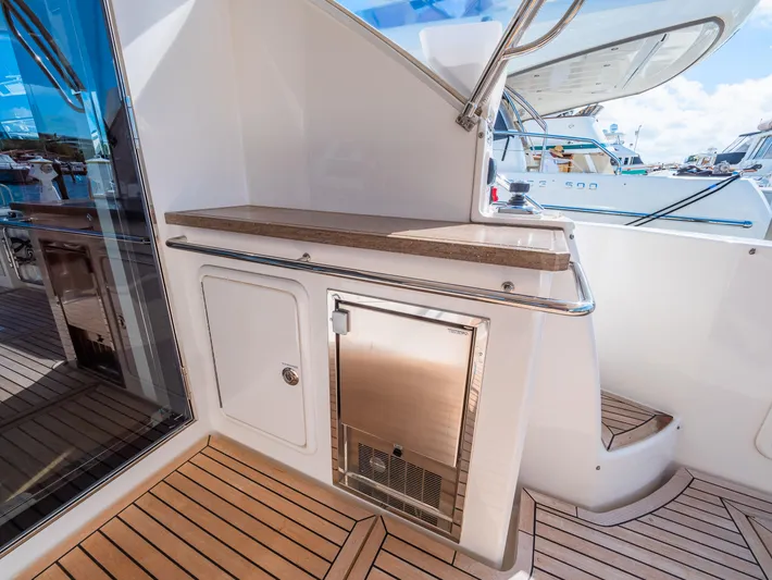 Belle-rosa Yacht Photos Pics 2016 Riviera 5000 Sport Yacht with sleek teak decking and stainless steel accents.