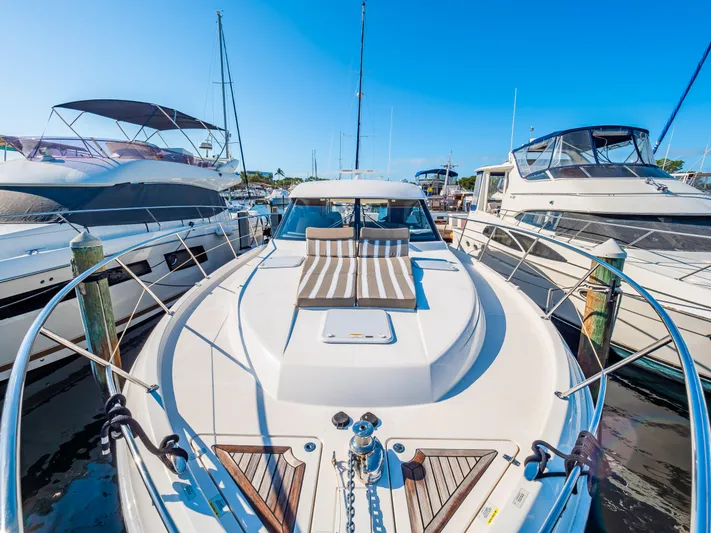 Belle-rosa Yacht Photos Pics 2016 Riviera 5000 Sport Yacht docked, surrounded by other boats.