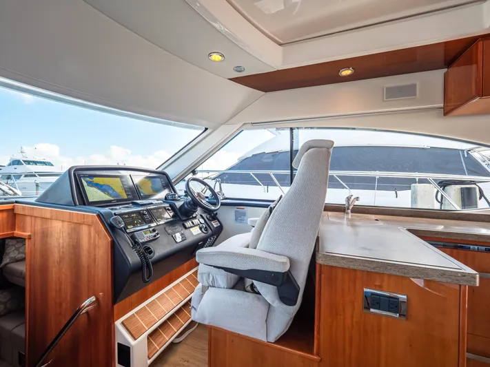 Belle-rosa Yacht Photos Pics Interior of 2016 Riviera 5000 Sport Yacht with helm station.