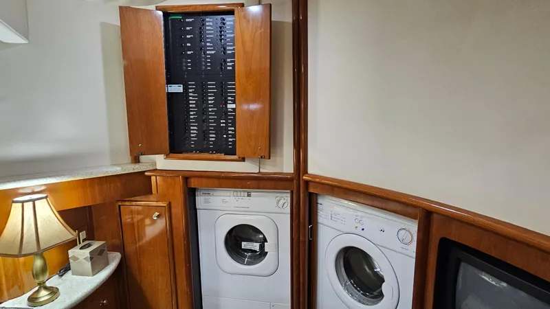  Yacht Photos Pics Laundry area in 2000 Carver 450 Voyager Pilothouse with washer, dryer, and electrical panel.