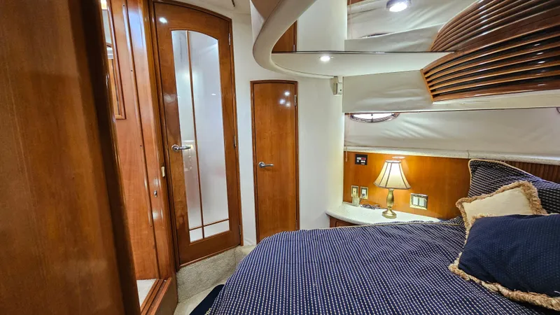  Yacht Photos Pics Interior of 2000 Carver 450 Voyager Pilothouse with cozy bedroom and wooden accents.