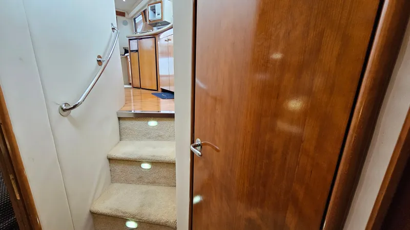  Yacht Photos Pics Interior of 2000 Carver 450 Voyager Pilothouse with carpeted stairs and wooden door.