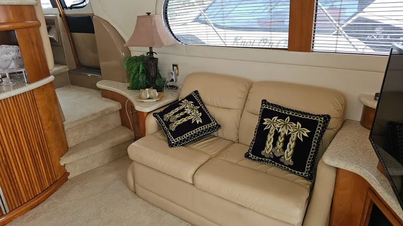  Yacht Photos Pics Interior of 2000 Carver 450 Voyager Pilothouse with beige sofa and decorative pillows.