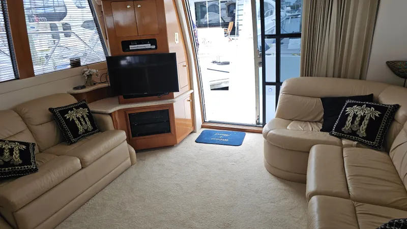  Yacht Photos Pics Luxurious interior of 2000 Carver 450 Voyager Pilothouse with beige leather seating and TV.