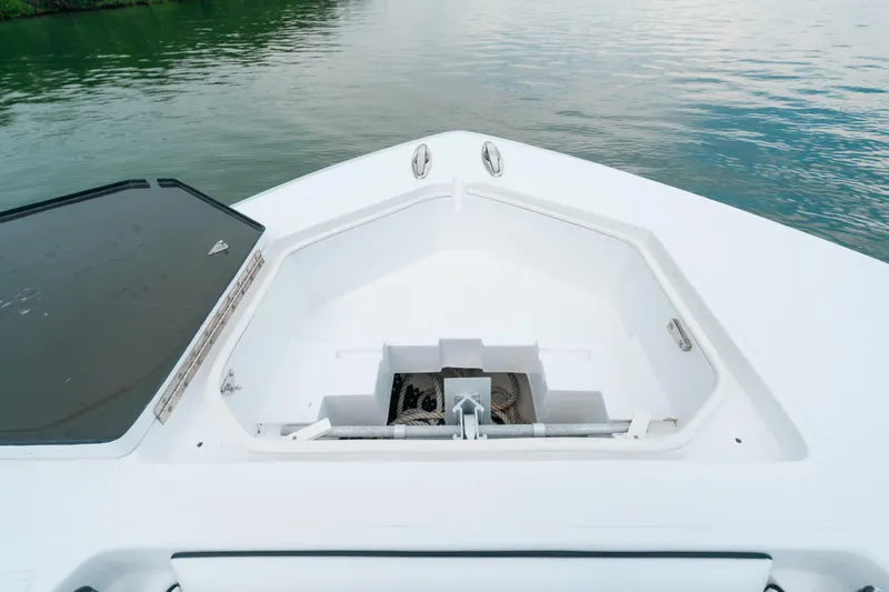  Yacht Photos Pics Bow of 2013 SeaHunter 45 boat with anchor storage, on calm water.