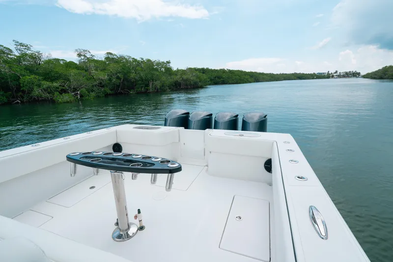  Yacht Photos Pics SeaHunter 45 boat, 2013 model, on calm water with lush greenery in the background.