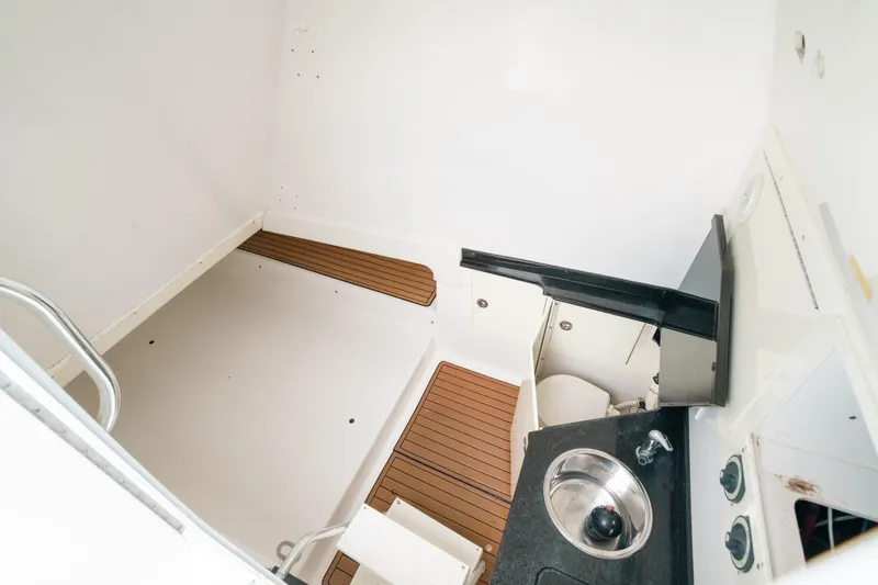  Yacht Photos Pics Interior of 2013 SeaHunter 45 boat with sink and wooden flooring.