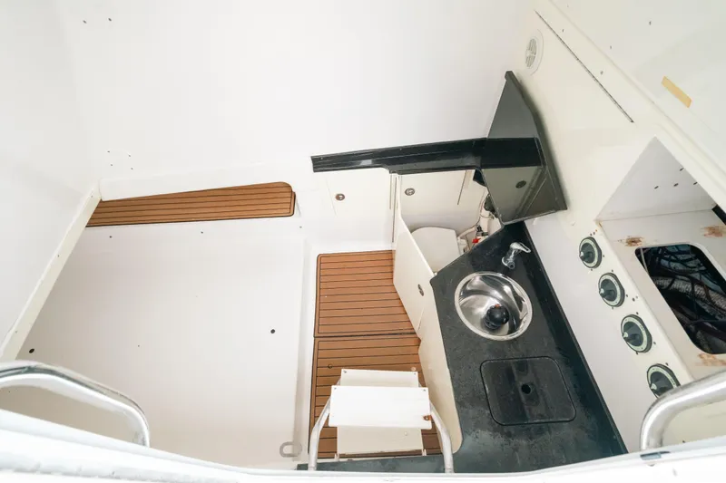  Yacht Photos Pics 2013 SeaHunter 45 interior with sink, wooden flooring, and compact design.