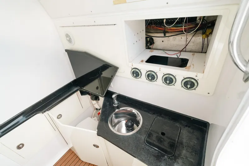  Yacht Photos Pics Interior of 2013 SeaHunter 45 boat with sink, storage, and control panel.