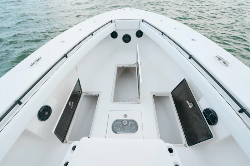  Yacht Photos Pics Bow of 2013 SeaHunter 45 boat with open storage compartments on calm water.