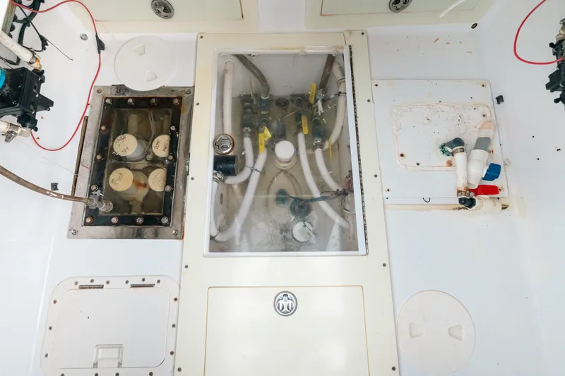  Yacht Photos Pics Engine compartment of a 2013 SeaHunter 45 boat, showcasing mechanical components and wiring.