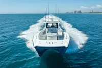 2019 Freeman 42 boat cruising on open blue ocean near city skyline.