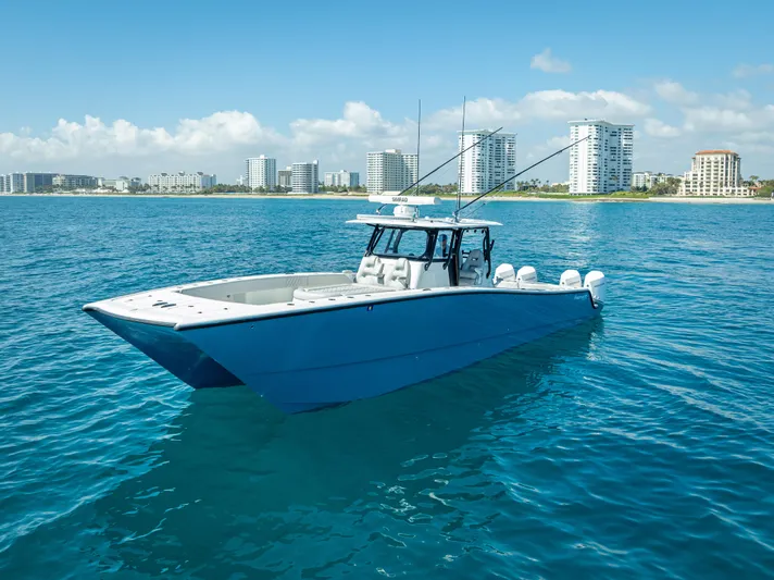  Yacht Photos Pics 2019 Freeman 42 boat on blue ocean with city skyline in background.