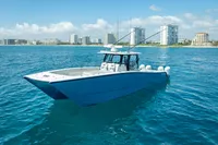 2019 Freeman 42 boat on blue ocean with city skyline in background.