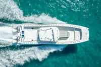 Aerial view of 2019 Freeman 42 boat cruising on clear turquoise water.