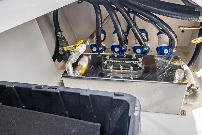  Yacht Photos Pics Engine compartment of a 2019 Freeman 42 boat, featuring hoses and a metal component.