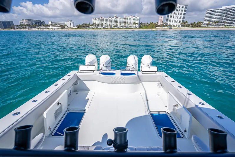  Yacht Photos Pics 2019 Freeman 42 boat with quad engines, ocean view, and city skyline in the background.