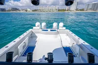 2019 Freeman 42 boat with quad engines, ocean view, and city skyline in the background.