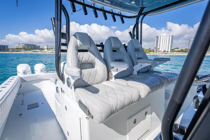  Yacht Photos Pics Luxurious seating on a 2019 Freeman 42 boat with ocean and cityscape backdrop.