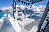 Luxurious seating on a 2019 Freeman 42 boat with ocean and cityscape backdrop.