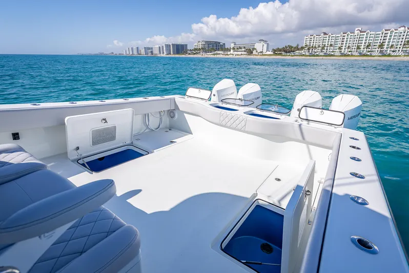  Yacht Photos Pics 2019 Freeman 42 boat on clear blue water near a coastal cityscape.