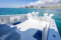 2019 Freeman 42 boat on clear blue water near a coastal cityscape.