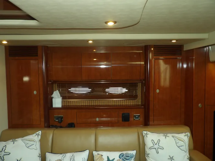 Parrotdise Yacht Photos Pics Interior of 2005 Sea Ray 390 Sundancer with wooden cabinetry and beige seating.