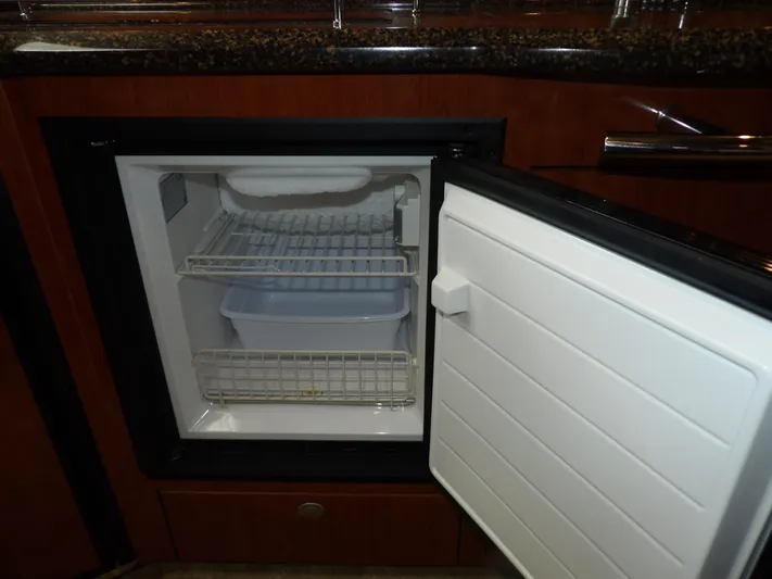 Parrotdise Yacht Photos Pics Open mini fridge in 2005 Sea Ray 390 Sundancer yacht kitchen.