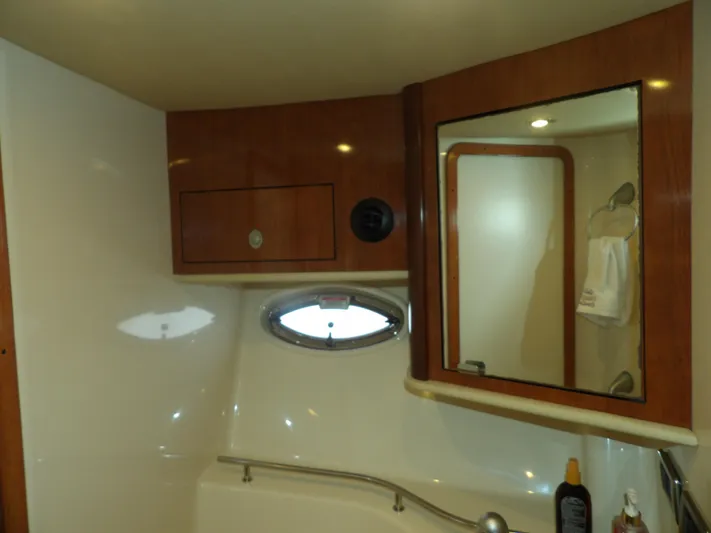 Parrotdise Yacht Photos Pics 2005 Sea Ray 390 Sundancer bathroom with wooden cabinets and mirror.