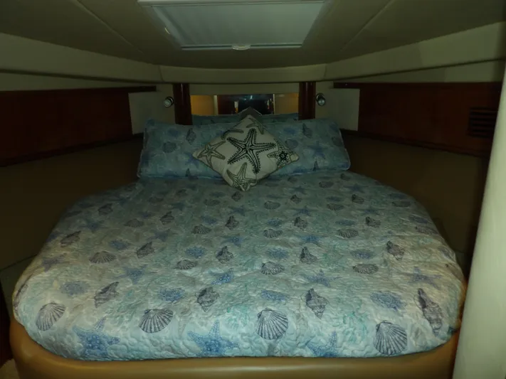 Parrotdise Yacht Photos Pics Cozy bedroom in 2005 Sea Ray 390 Sundancer with seashell-themed bedding.