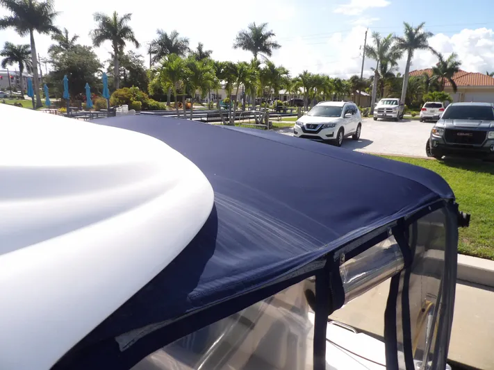 Parrotdise Yacht Photos Pics 2005 Sea Ray 390 Sundancer with blue canvas top in marina parking lot.