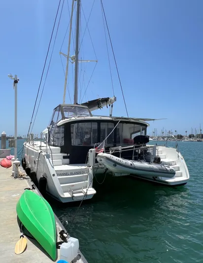 Celestra Yacht Photos Pics 2017 Lagoon 400 S2 catamaran docked at marina with kayak and dinghy.
