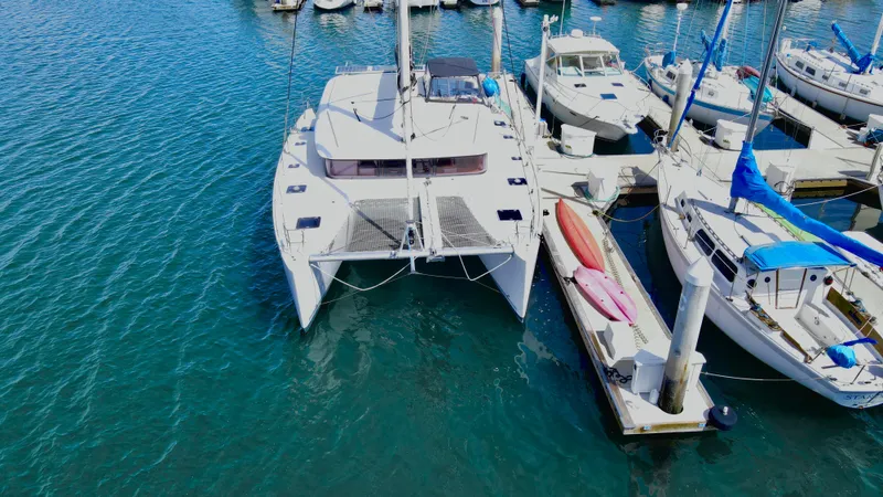 Celestra Yacht Photos Pics 2017 Lagoon 400 S2 catamaran docked in marina, surrounded by other boats.