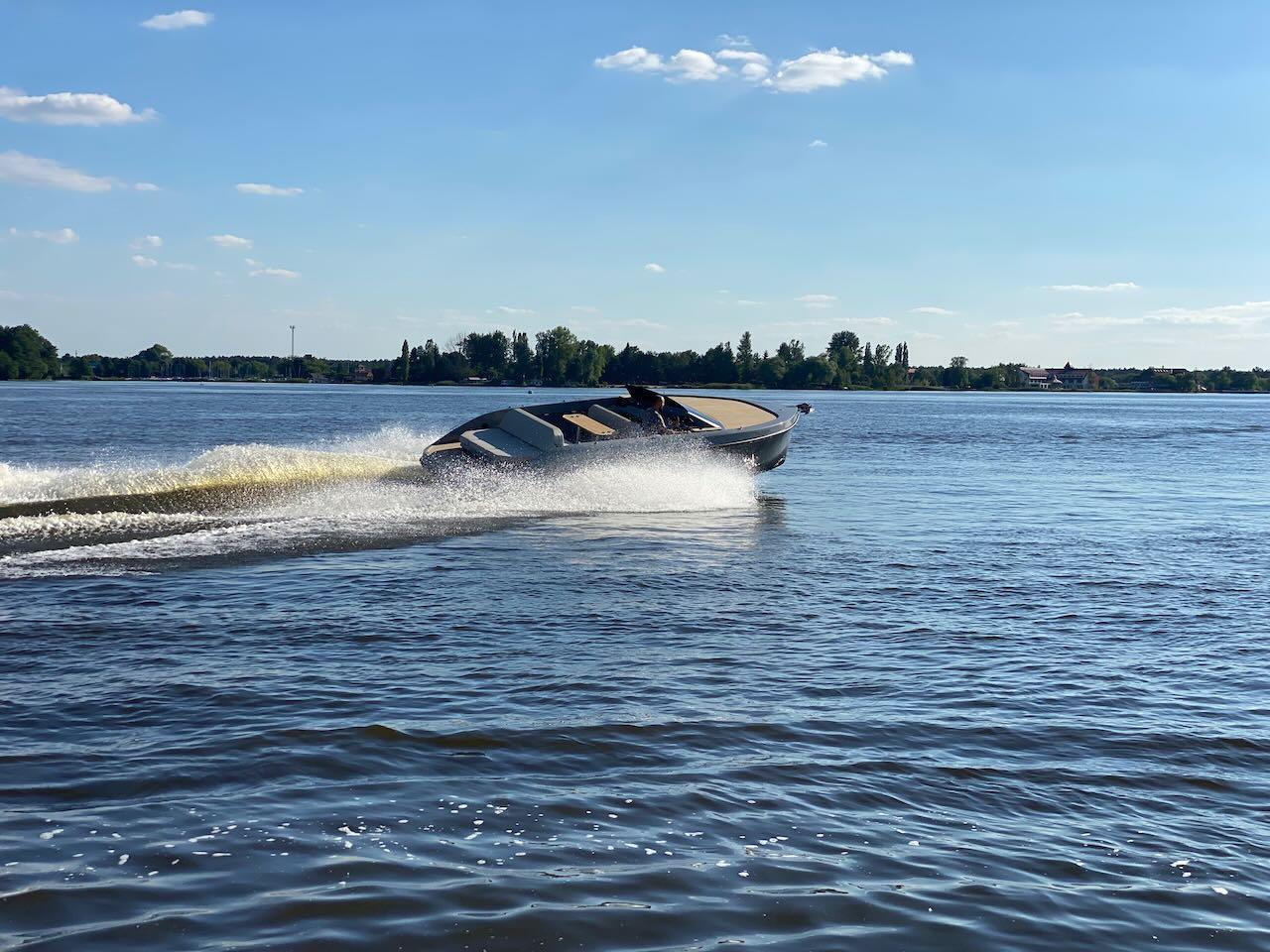 2022 Rand Spirit 25 speedboat cruising on a sunny lake.