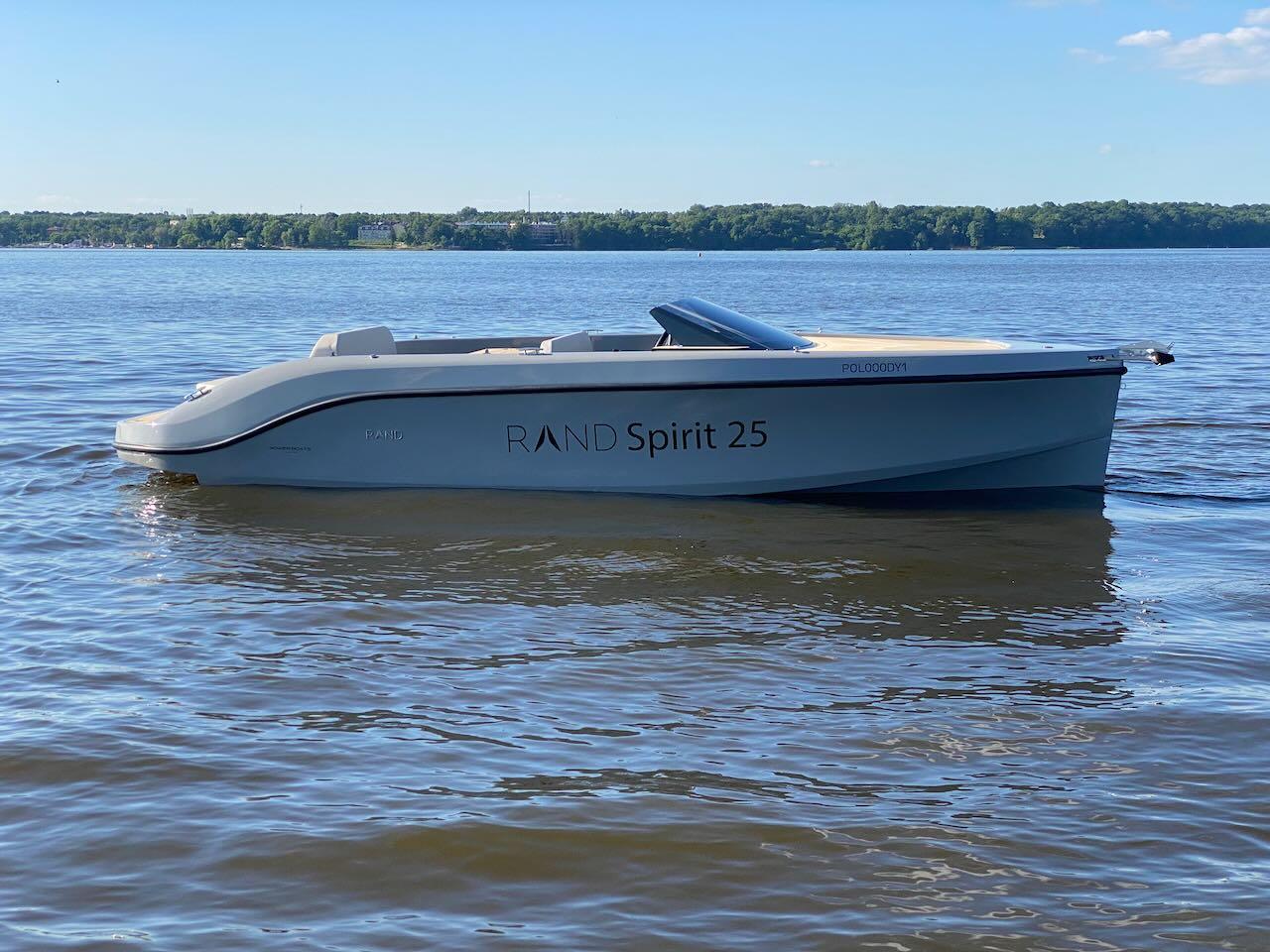 2022 Rand Spirit 25 boat on calm lake waters.