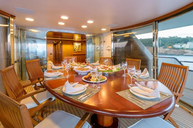  Yacht Photos Pics Luxurious dining setup on 1995 Cantieri Navali Nicolini 43 yacht, featuring elegant tableware and scenic views.