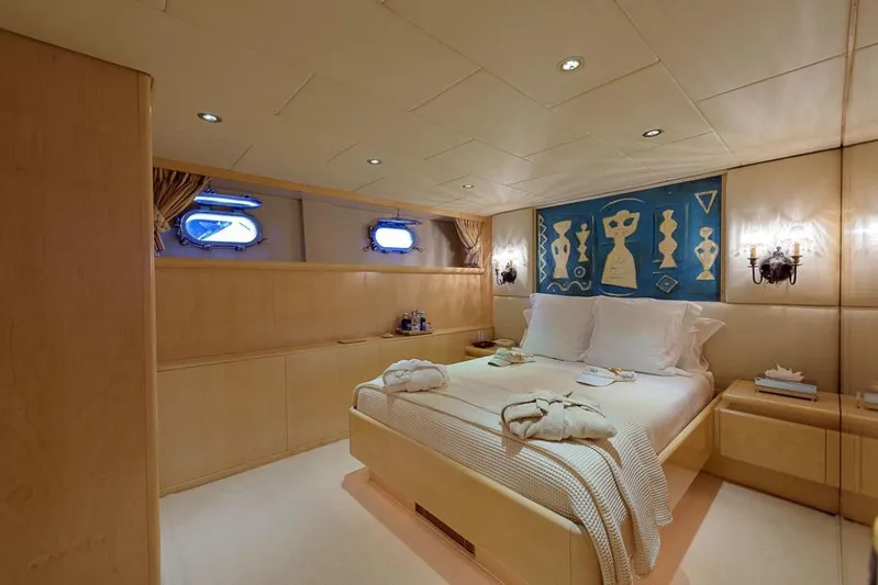  Yacht Photos Pics Luxurious bedroom interior on 1995 Cantieri Navali Nicolini 43 yacht, featuring elegant decor and artwork.