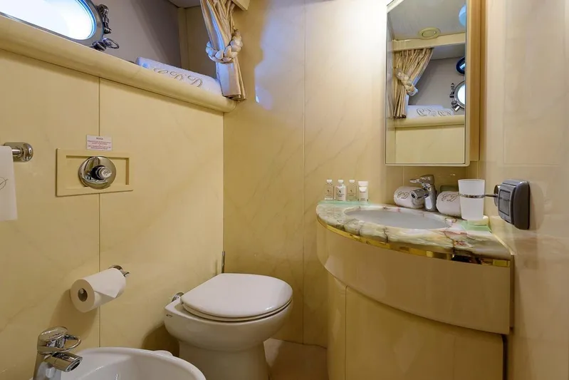  Yacht Photos Pics Luxurious bathroom on 1995 Cantieri Navali Nicolini 43 yacht, featuring elegant fixtures and marble countertop.