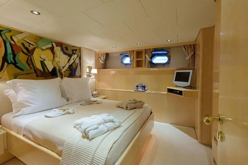  Yacht Photos Pics Luxurious bedroom on 1995 Cantieri Navali Nicolini 43 yacht, featuring elegant decor and modern amenities.