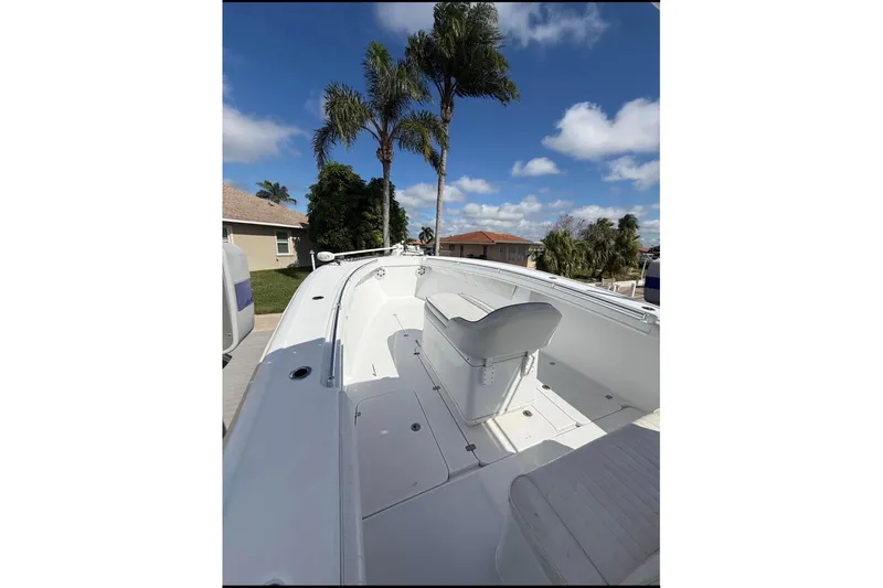  Yacht Photos Pics 2004 Yellowfin 36 Offshore boat deck with seating, under clear blue sky.